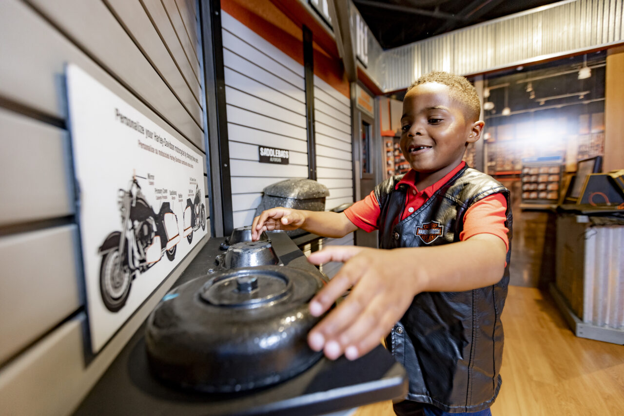 Boy choosing Harley parts to build bike